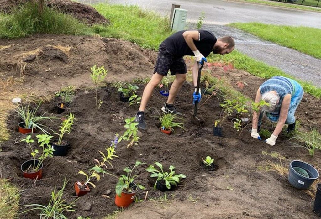 Brendon Samuels builds a rain garden.